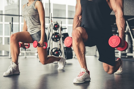 Two people working out with weights